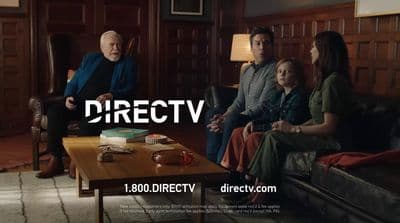 a group of people sitting on a couch in a living room