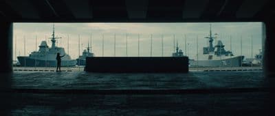 a person standing in front of a large ship