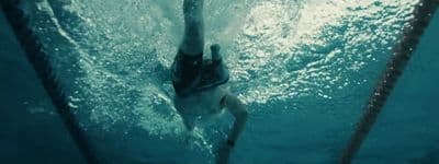 a man swimming in a pool of water