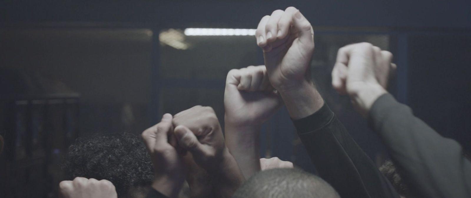 a group of people raising their hands in the air