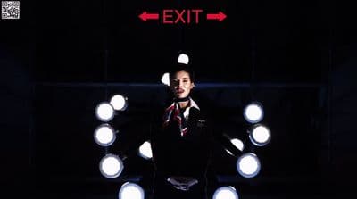a man standing in front of a bunch of lights