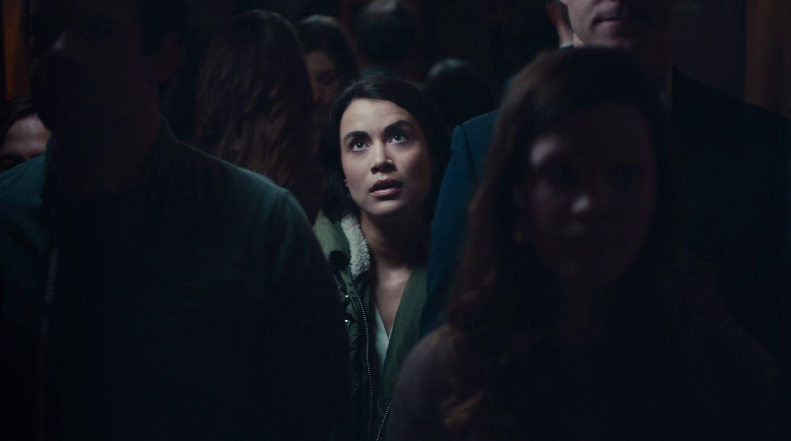 a woman standing in a crowd of people