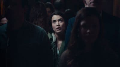 a woman standing in a crowd of people