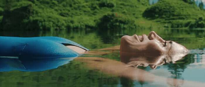 a man floating on top of a body of water