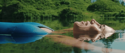 a man floating on top of a body of water