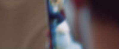 a blurry photo of a person holding a cell phone