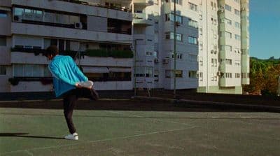 a person on a court with a tennis racket