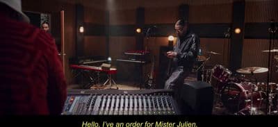 a man standing in front of a mixing desk