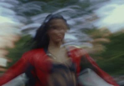 a blurry photo of a woman walking down a street