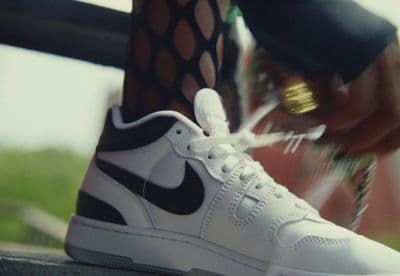 a close up of a person tying a shoelace