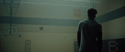 a man standing in front of a basketball hoop