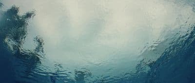 a view of a body of water with a sky in the background