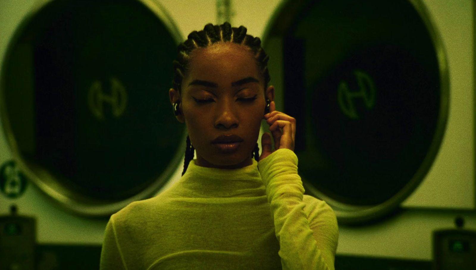 a woman with dreadlocks talking on a cell phone