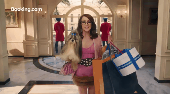 a woman in a pink dress holding shopping bags
