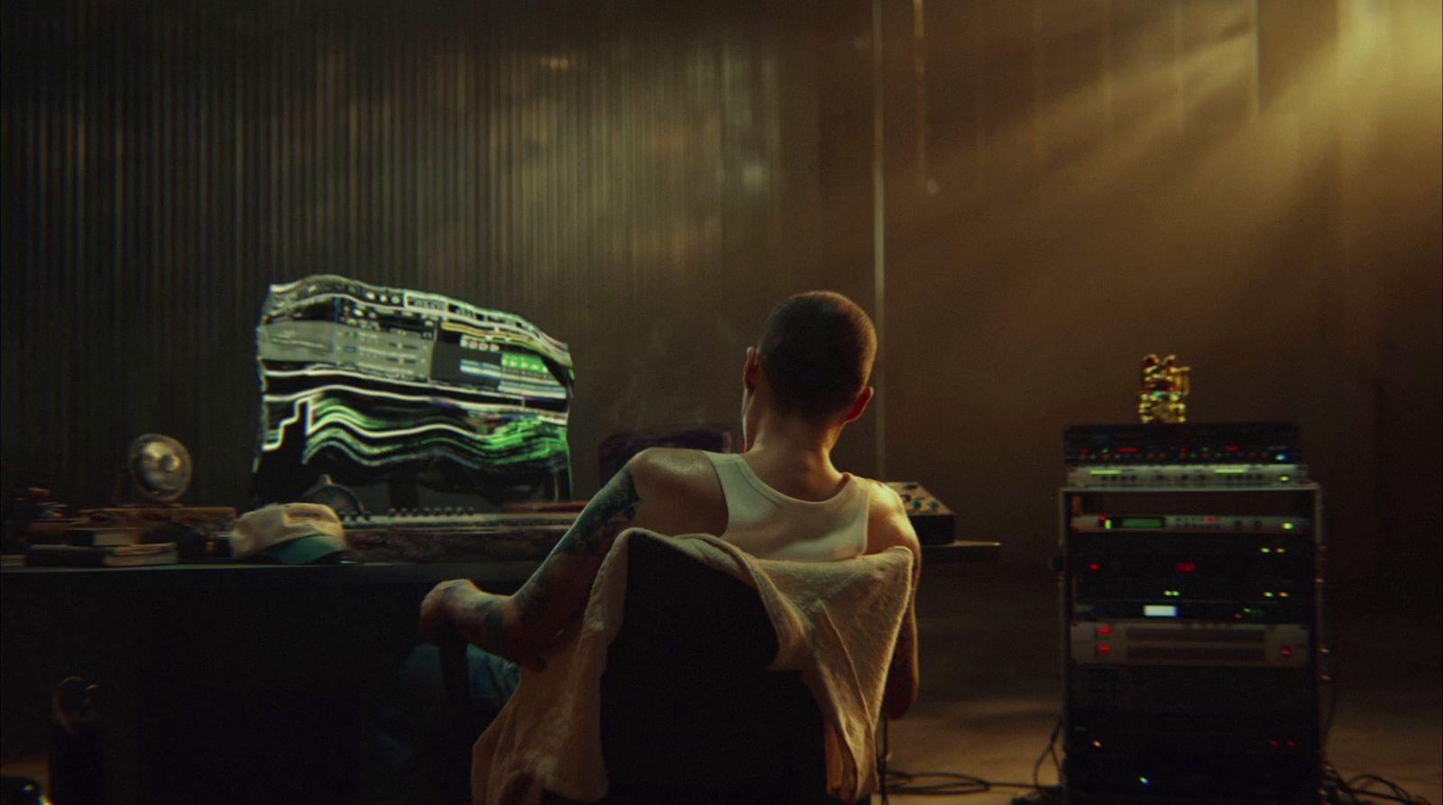 a man sitting in a chair in front of a computer