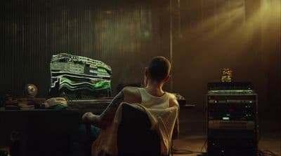 a man sitting in a chair in front of a computer