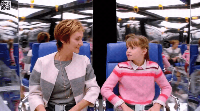 a woman sitting next to a child on a blue chair