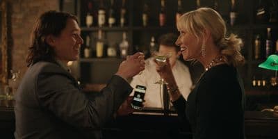 a woman holding a wine glass next to a man