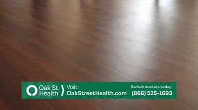 a wooden floor with a green sign that says oak st visit