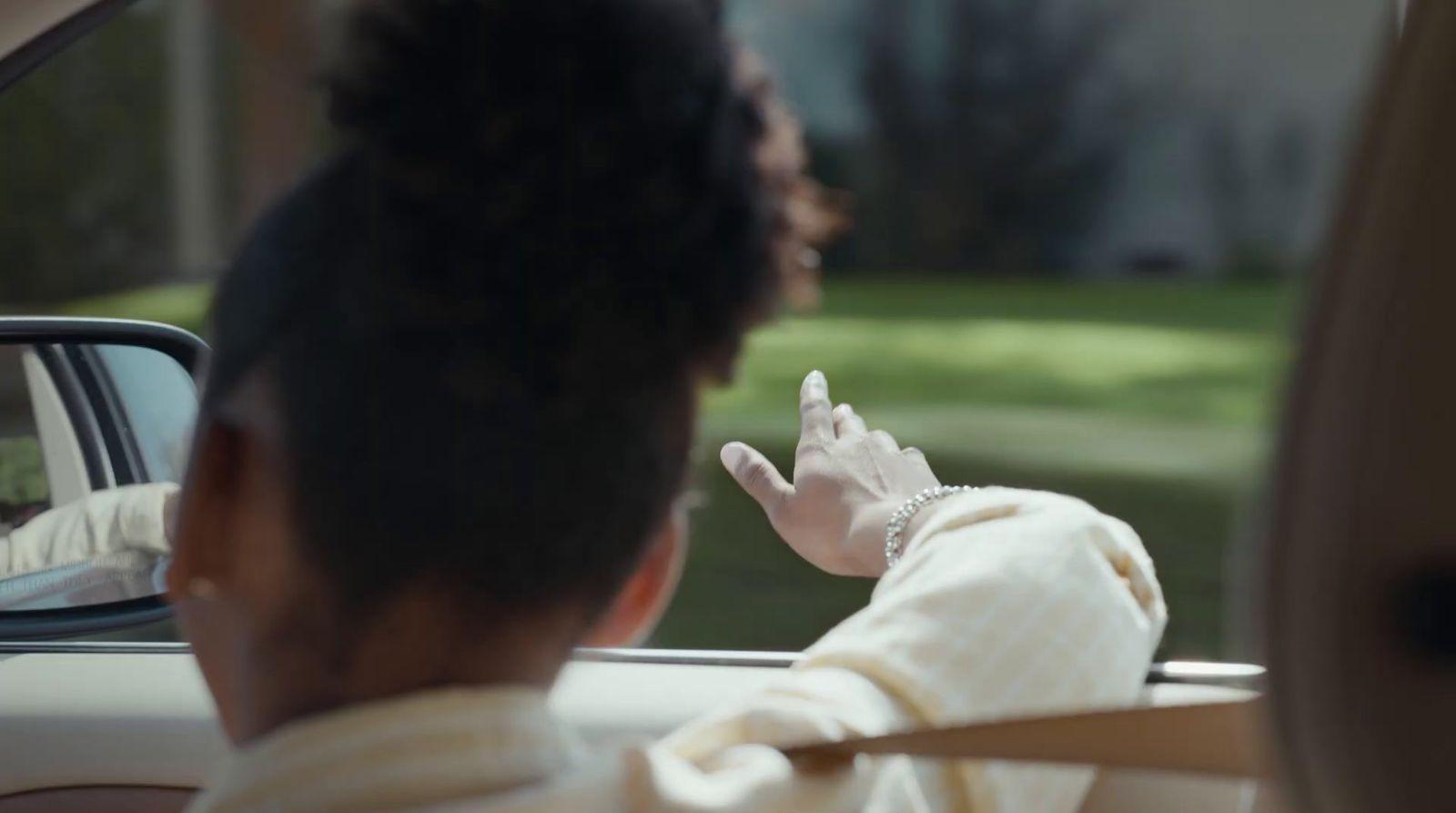 a woman sitting in a car talking on a cell phone