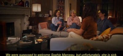 a group of people sitting around a living room together