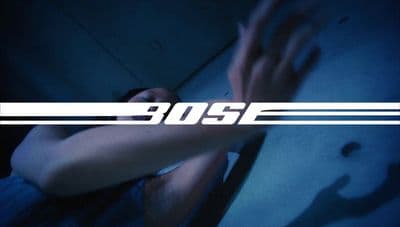 a woman with her arm around a wall with the word boss on it