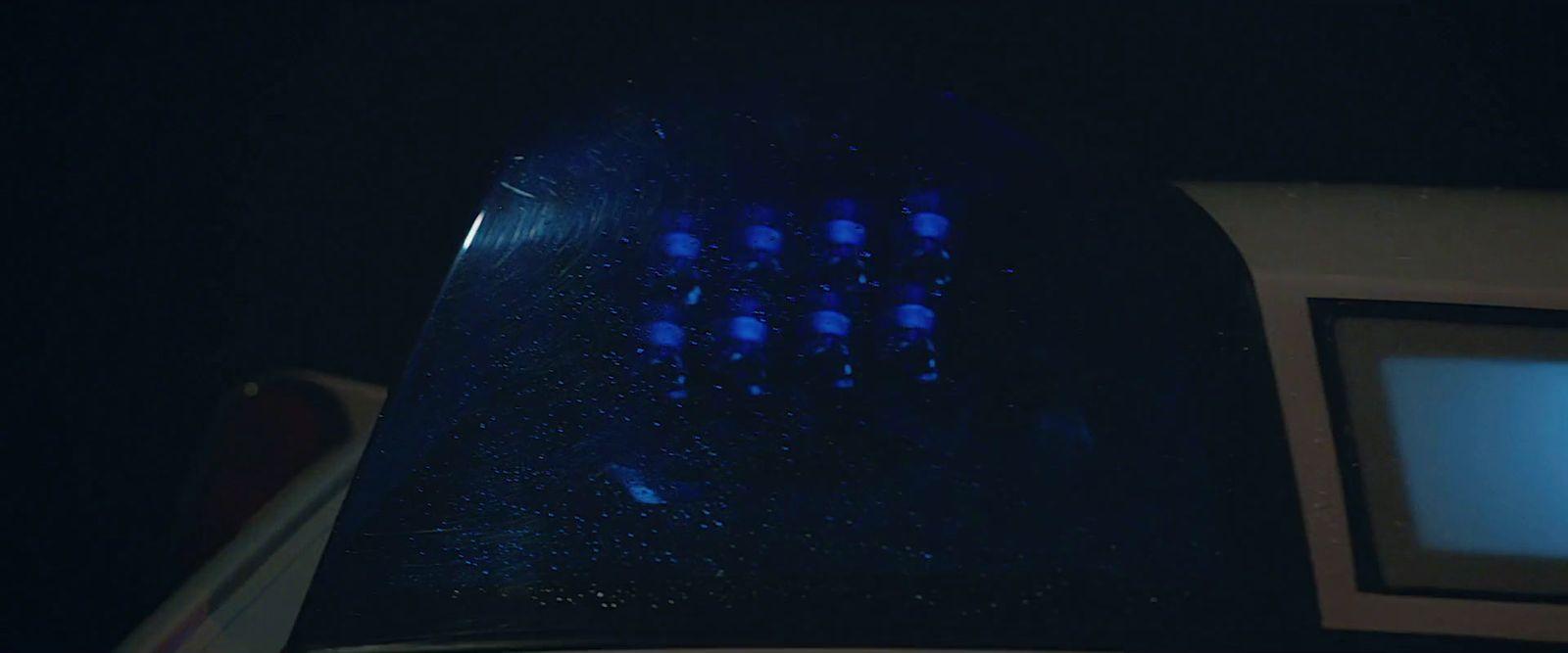 a close up of a blue light in the dark