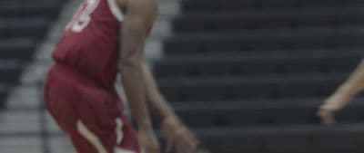 two basketball players are playing a game of basketball