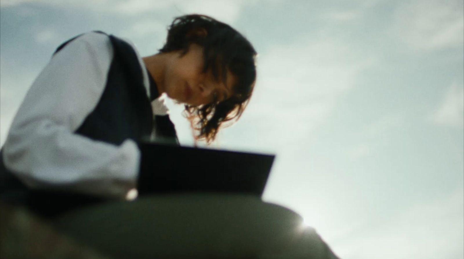 a woman with a laptop sitting on a bench