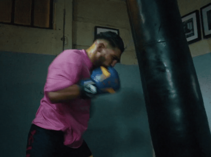 a man in a pink shirt is boxing