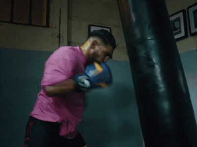 a man in a pink shirt is boxing