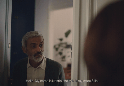 a man in a suit looking at himself in the mirror