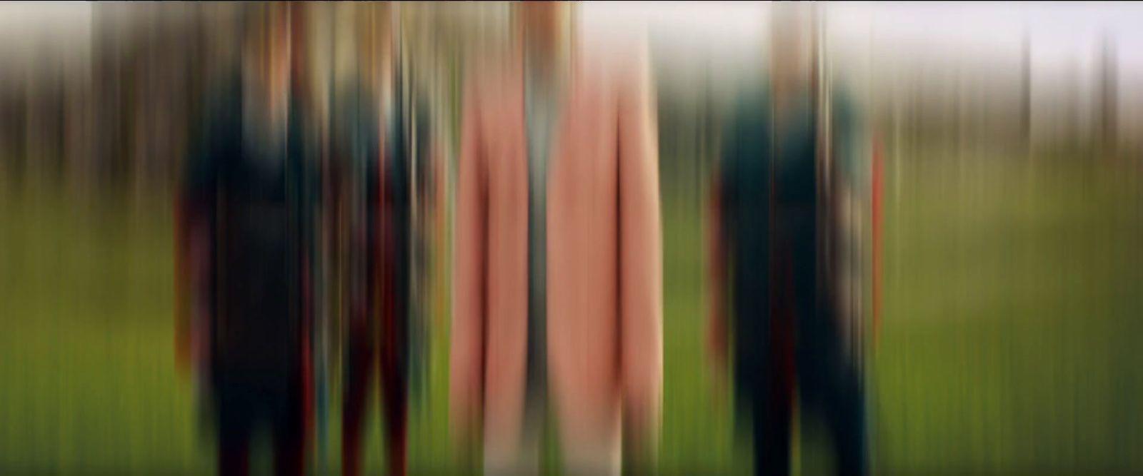 a blurry photo of a group of people standing in a forest