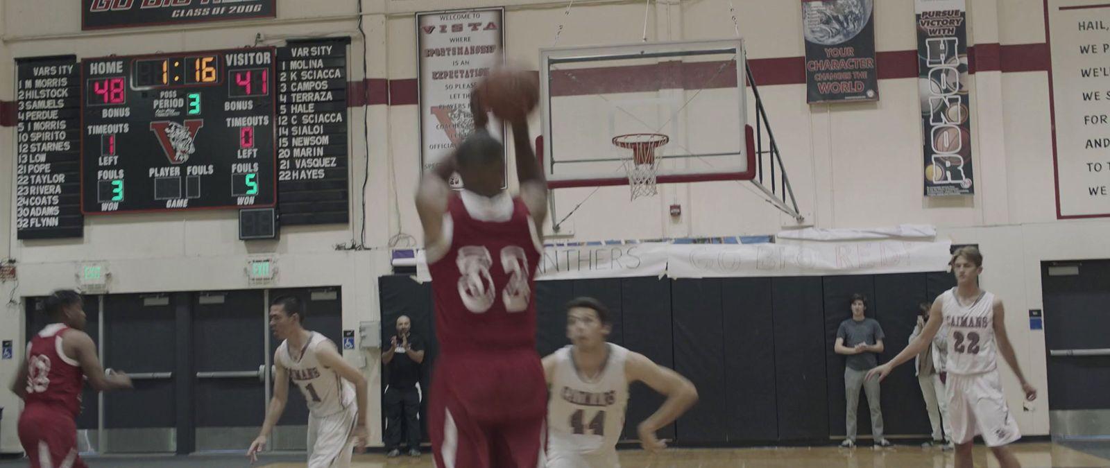 a group of young men playing a game of basketball