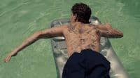 a man laying on a raft in the water