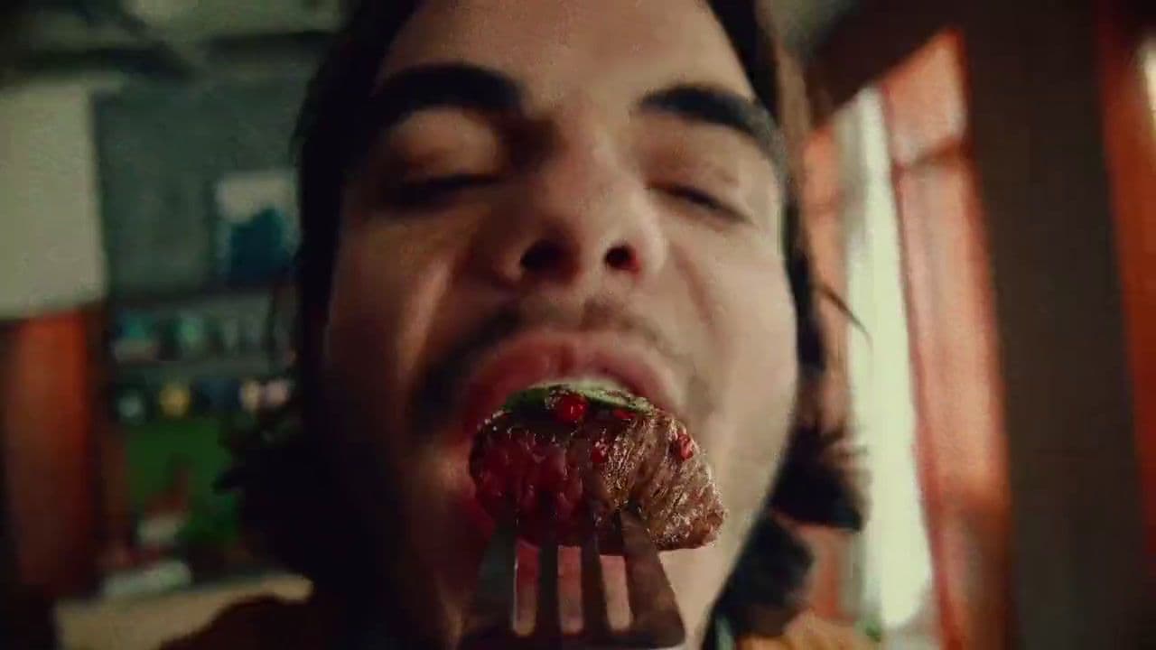 a man eating a piece of food with a fork