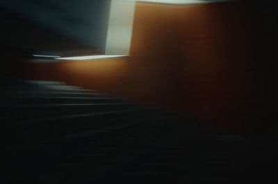 a blurry photo of a stair case in a dark room
