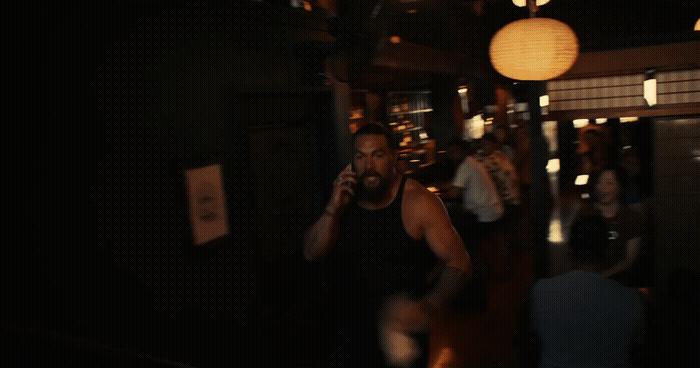 a man talking on a cell phone in a dark room
