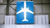a large blue sign with a white airplane on it