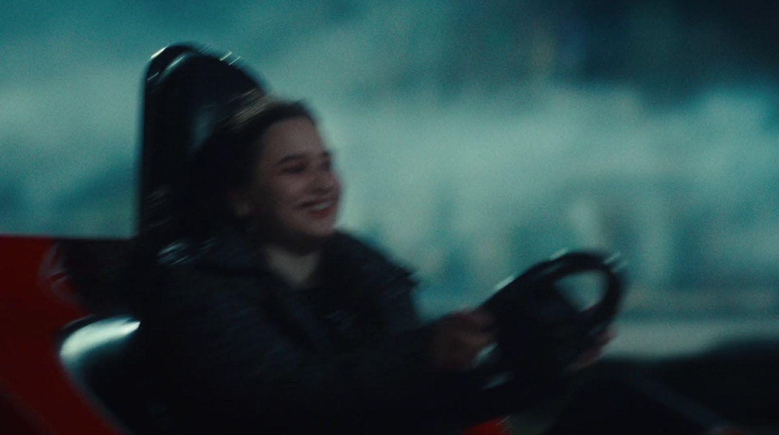 a woman driving a car in the dark