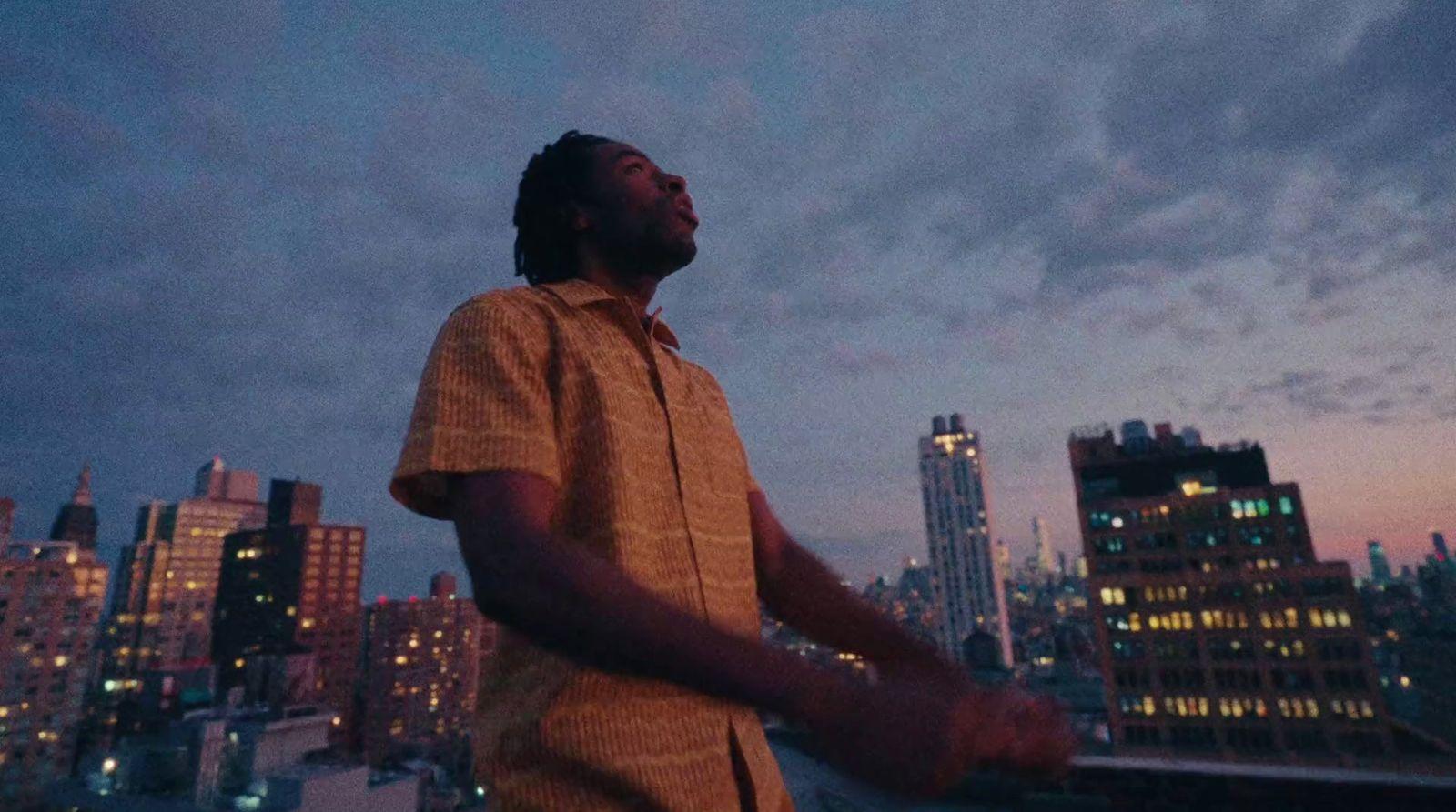 a man standing in front of a city skyline