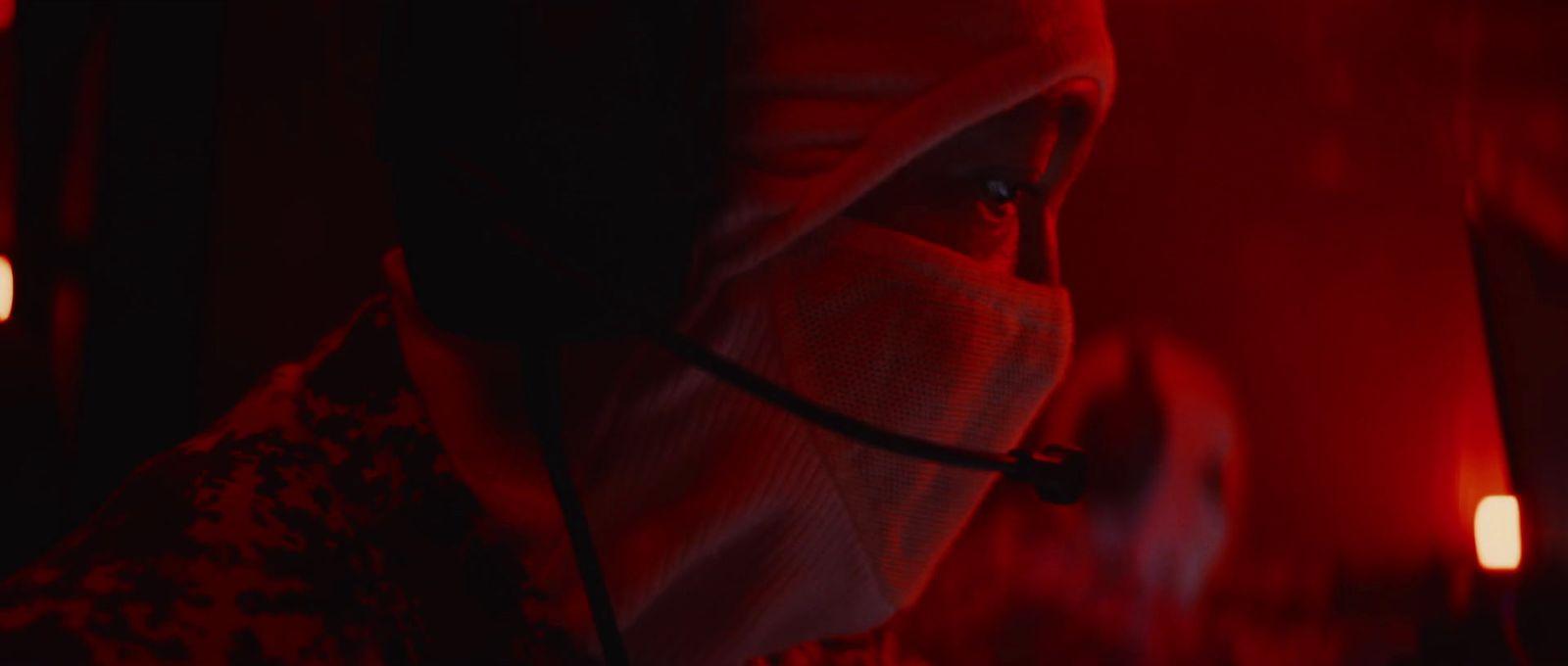 a person wearing a face mask in a dark room