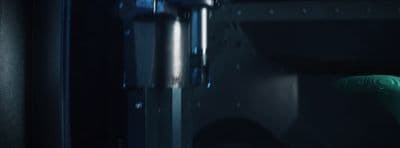 a close up of a green object in a dark room
