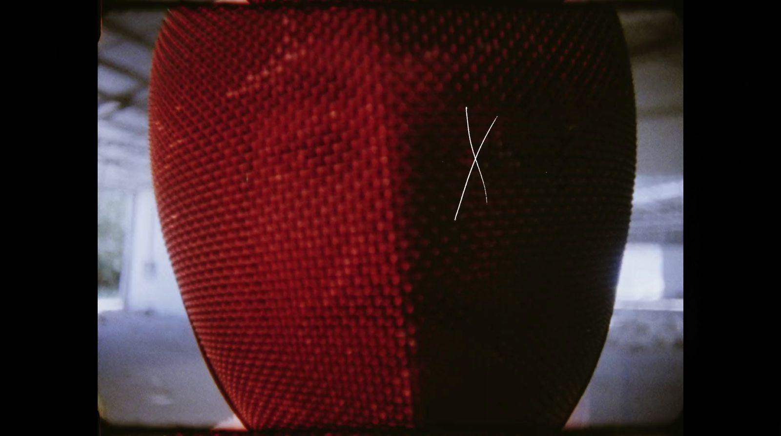 a close up of a red vase with a thread on it