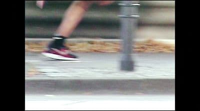 a blurry photo of a person running on a sidewalk