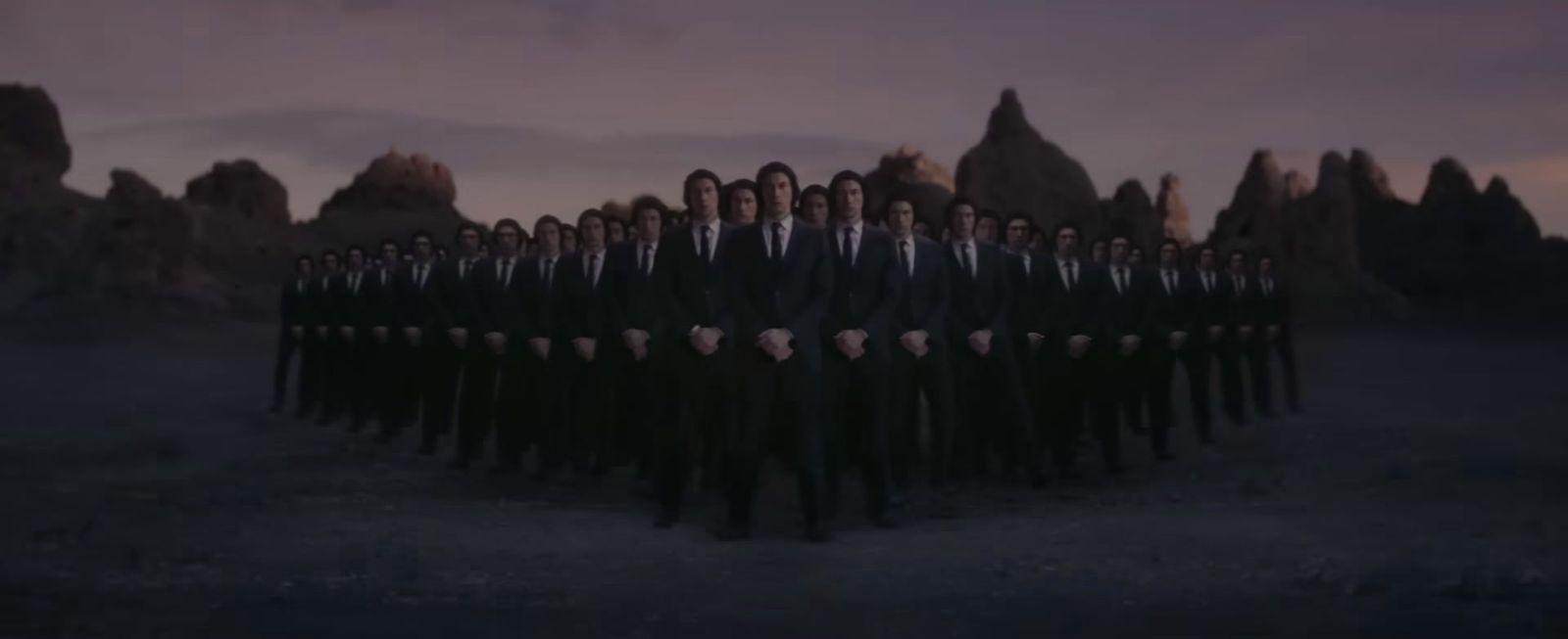 a group of men standing in front of a mountain