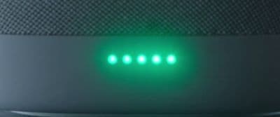 a close up of a green light on a speaker