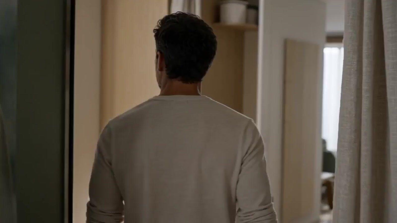 a man standing in front of a mirror in a room