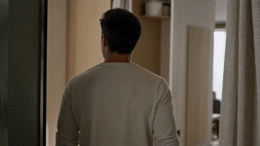 a man standing in front of a mirror in a room