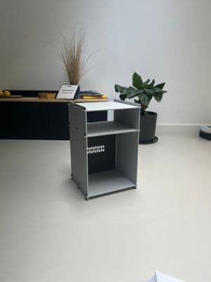 a desk with a plant on top of it